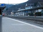 Ein IC 2000 und eine Re 4/4 II mit ihrem IR fahren durch Sissach am 24.02.2009